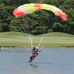 Three skydivers from OC Skydiving dropped down on the opening festivities for the 15th Annual Stephen Decatur golf tournament at Eagle’s Landing on Tuesday. Pictured above, a skydiver skims across the pond near the first tee on Tuesday.Photo by Shawn Soper