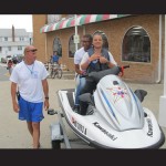 Ocean City Beach Patrol Lt. Ward Kovacs lets two foreign student workers try sitting on one of the patrol’s waverunners. 