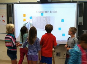 OC Elementary Students Identify Traits Of Characters Posting Them On The Smartboard