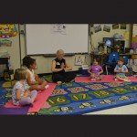 Carol Pike leads kindergarten students in a yoga storytelling session.
