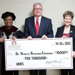 UMES President Juliette Bell accepts a ceremonial check representing a donation by Nicholas Blanchard, the university’s former pharmacy school dean, to underwrite a health care speakers’ symposium. UMES development director Veronique Diriker is also pictured.