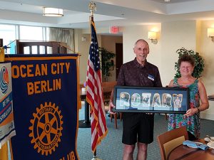Rotary Club District Governor Elect Presents Rotary Club President With A Framed Collage