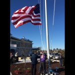 Veterans Nate Pearson and John Sauer are pictured with Ocean Pines Association General Manager Bob Thompson raising a flag from Normandy last weekend. 