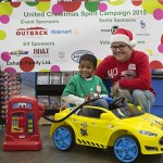 Jalil Farmer is pictured at last weekend’s United Christmas Spirit Campaign event with his chosen gift and shopping spree chaperone, Scott Lenox. Photos by Dana Marie Photography