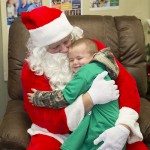 Area resident Jack Phillips gives Santa Claus a squeeze after shopping in Walmart last Saturday morning.