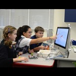 Lower school students Ava Vane, Haris Gjikuria and Timmy Hebert working on a Lego Education WeDo project during an Hour of Code instruction on Tuesday.