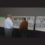 Planning and Community Development Director Bill Neville and Councilman Dennis Dare look over some of the designs presented at Tuesday’s meeting.