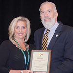 Atlantic General Hospital’s Tracey Mullineaux is pictured with Maryland Health and Mental Hygiene Secretary Van Mitchell accepting the Gold Wellness at Work award.