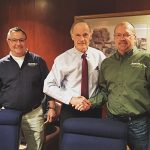 Delaware Senator Tom Carper, center, congratulates Atlantic Millwork & Cabinetry President Mark Woodruff and co-owner Patrick Reed on their warehouse’s new solar panel project, which is pictured on the right. Photos by Vincent McDowell, above, and TJ Redefer, right.
