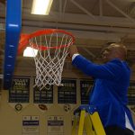After Stephen Decatur’s boys’ varsity basketball team wrapped up the state 3A-East region championship last weekend, Coach B.J. Johnson started his players and staff on the time-honored tradition of cutting down the nets. Photo by Shawn Soper