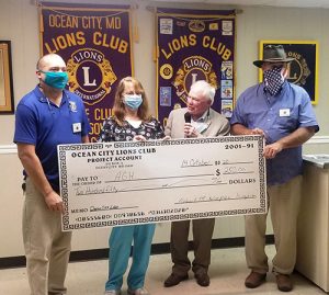 OC Lions Present Check To AGH Education Coordinator